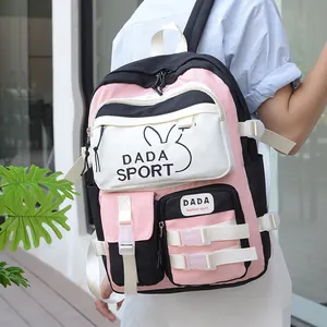 Outdoor model shot showing the pink and black color-block casual nylon backpack details