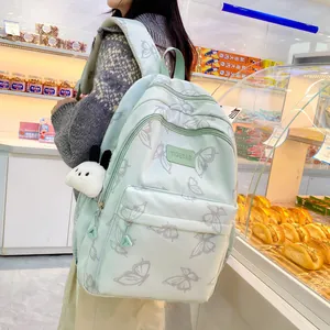 Mochila escolar verde menta con estampado de mariposas y accesorio de colgante de perrito