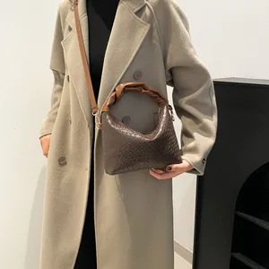 Chic dark brown hobo bag with pleated handle and woven texture for fashionable women