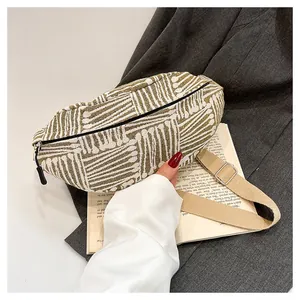 Detailed view of woven geometric pattern canvas chest bag with adjustable strap and silver buckle