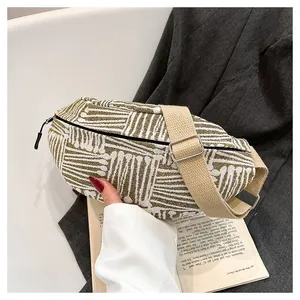 Detailed view of canvas chest bag with olive green stripes and adjustable woven strap