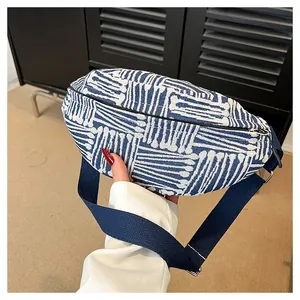 Close-up of blue and white geometric pattern canvas belt bag with adjustable strap