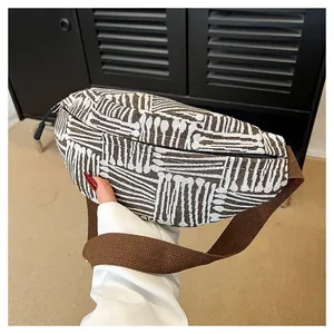 Detailed close-up of ethnic stripe canvas chest bag with woven fabric and durable strap