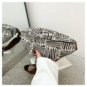 Detail view of ethnic style canvas chest bag featuring brown geometric striped patterns