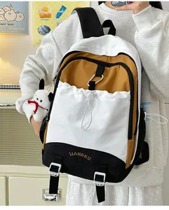 Detail des dreifarbigen Nylon-Schulrucksacks mit Plüschwelpen-Anhänger und Kordelzugtasche