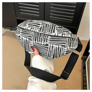 Detail view of ethnic canvas waist bag with black and white geometric woven stripes