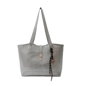 Silver large shoulder tote bag with gold metal buckle and woven rope pendant decoration