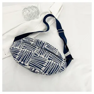 Detailed view of blue and white striped canvas chest bag with adjustable strap