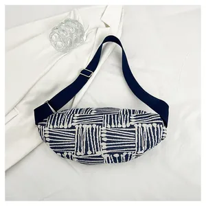Detailed close-up of blue and beige woven canvas fanny pack with striped texture