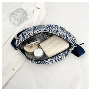 Internal view of blue ethnic canvas waist bag showing storage space and capacity