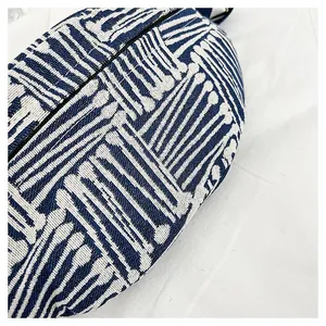 Macro shot of ethnic stripe canvas chest bag featuring woven texture and blue metal zipper