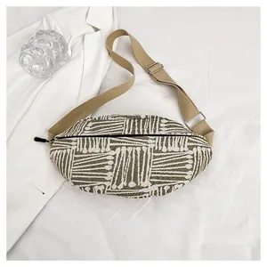 Flat lay of ethnic canvas waist bag with geometric patterns and adjustable canvas strap