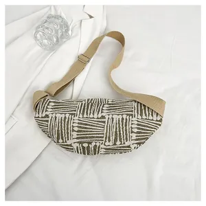 Detail of crescent canvas chest bag showing olive jacquard fabric and metal buckle