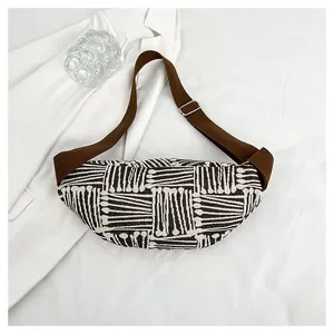 Detail view of ethnic crescent bag showing geometric weave texture and adjustable strap