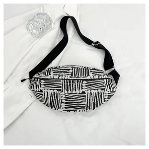 Detail of woven black and white striped texture on the stylish canvas crossbody bag