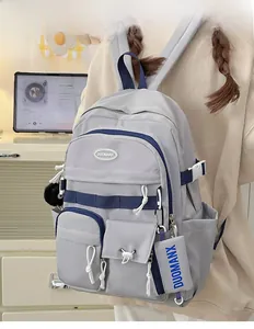 Detail view of a gray nylon backpack with functional pockets and blue strap accents