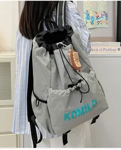 Light gray nylon drawstring backpack for outdoor sports with a cute plush bear charm