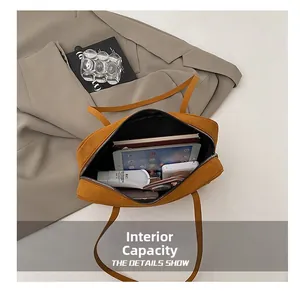 Internal capacity of the yellow frosted shoulder bag showing tablet and books