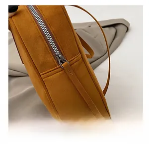 Close-up of a high-quality metal zipper and matte texture on a vintage mustard yellow handbag