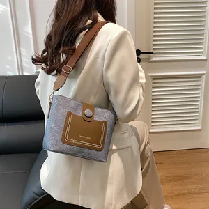 Winter stylish wool bucket bag with brown wide strap and leather pocket detail