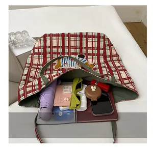 Detailed interior of checkered canvas tote showing its spacious capacity for daily essentials