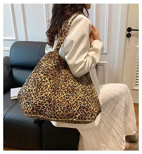 Fashionable leopard print tote bag styled with a minimalist white suit for a trendy look