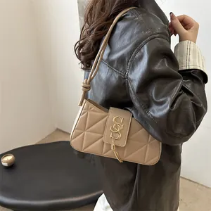 Beige quilted hobo shoulder bag with crescent design and gold tassel hardware for women
