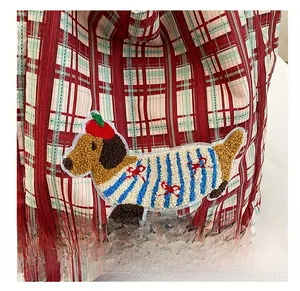 Detailed view of plaid canvas tote bag with high-quality dachshund embroidery and red patterns