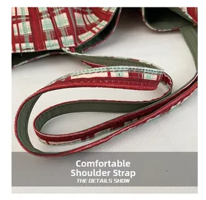 Detail of red and green plaid tote bag showing comfortable reinforced canvas shoulder straps