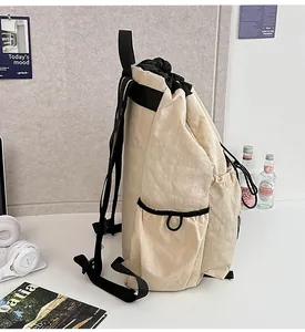 Close-up of lightweight drawstring backpack with side pockets on a minimal desk