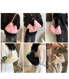 Close-up of bubble texture handbags with colorful flower charms and tubular straps