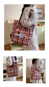 Detail of red plaid tote bag with cute dachshund embroidery shown in use from multiple angles