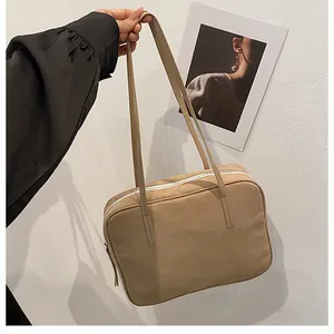Detailed view of vintage matte brown rectangular tote bag with contrasting white zipper