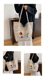 Close-up of cute dog embroidery on a large capacity striped canvas tote bag detail