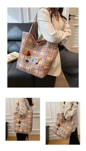 Close-up of checkered canvas tote bag featuring cute dachshund embroidery and premium texture
