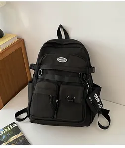 Detail of black Japanese style backpack with multi-pocket design and small side pouch