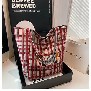 Detail of red and green plaid canvas tote bag with 3D cartoon dachshund embroidery