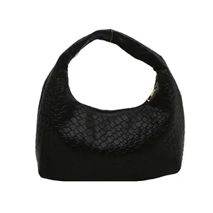Minimalist black woven hobo shoulder bag with crescent shape and gold zipper detail