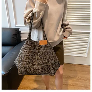 Leopard print tote bag with large front pocket and brown leather patch details