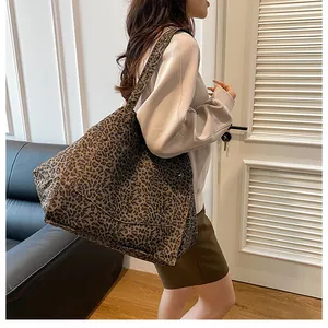 Close-up of leopard print tote bag showing the side pocket and canvas texture