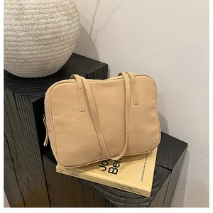 Close-up of beige minimalist rectangular shoulder bag on carbonized wood decor