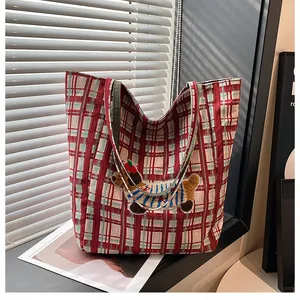 Close-up of red plaid canvas tote bag featuring a cute 3D embroidered puppy patch