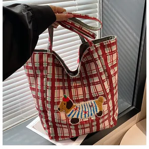 Detail of red checkered canvas tote bag with cute dachshund puppy embroidery and wide handles