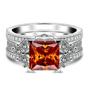 Dettaglio dell'anello con moissanite arancione taglio princess e pavé di diamanti