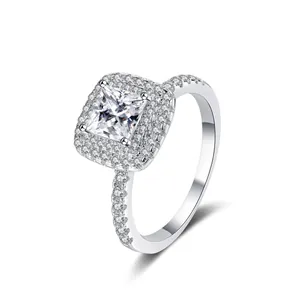 Close-up of a princess cut moissanite ring with halo setting in 925 sterling silver
