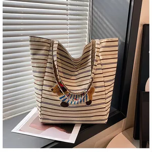 Detailed close-up of a striped tote bag with a cute 3D cartoon puppy patch embroidery