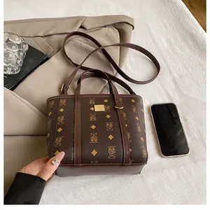 Detailed view of brown monogram bucket bag with gold hardware and stylish accessories
