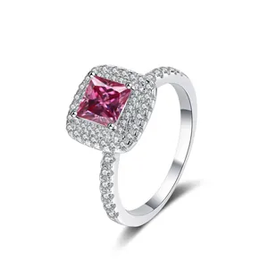Macro view of pink princess cut moissanite ring with double halo and pavé setting