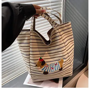 Close-up of corduroy tote bag featuring a cute dachshund embroidery and stripe pattern