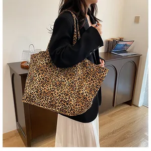 Leopard print tote bag with dual straps shown with business casual outfit in home office